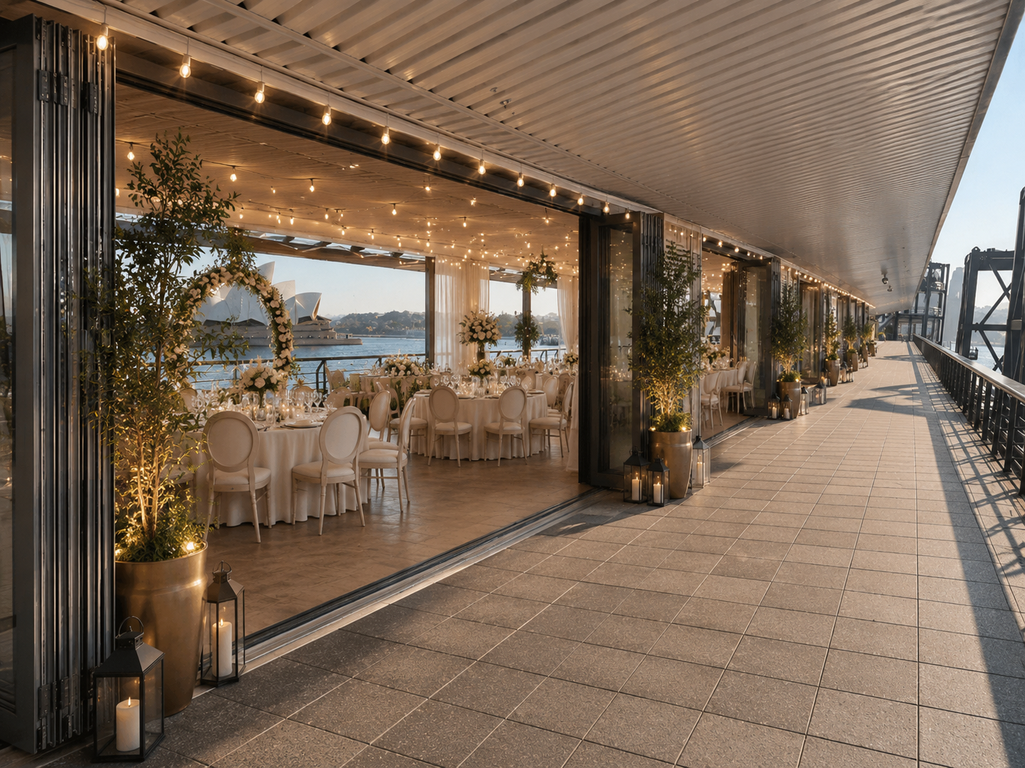 Floral ceremony arch framing the Sydney Opera House, with round tables set for the reception